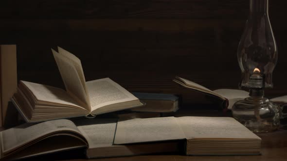 Old books lit with kerosene lamp light