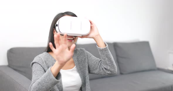 Woman Watch with Virtual Reality Device at Home