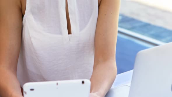 Female executive using digital tablet at desk 4k