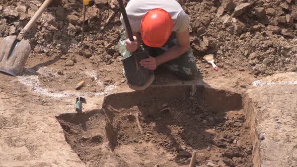 Young Archeologist Works on an Archaeological Site at Morning Sun Rays at Summer Heat