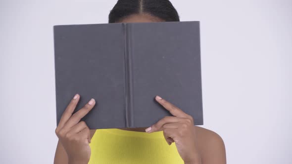 Happy Young Beautiful African Woman Hiding Behind Book