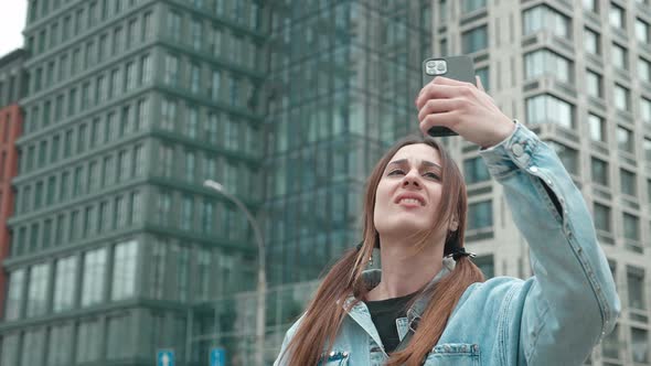 Young Woman Stand in Outdoor Feels Annoyed Having Problems with Smartphone