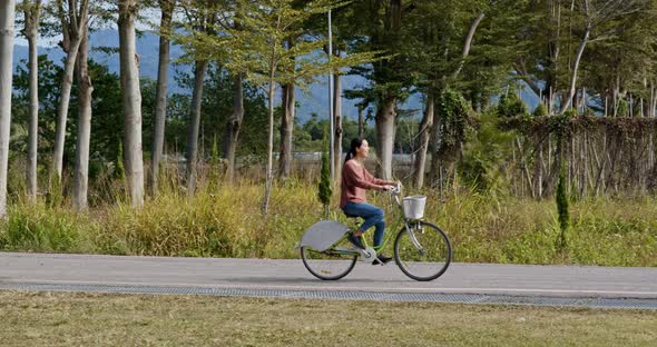 Woman ride a bike in countryside