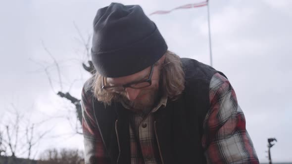 Carpenter In Glasses Working With Wood