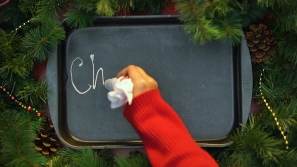 Christmas, Woman Writing Word With Cream on Baking Tray, Fest Celebration