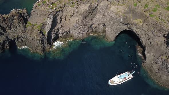 Aerial View on Pleasure Boat, People Swimming in Mediterranean Sea, Rocks and Mountain of Lipari