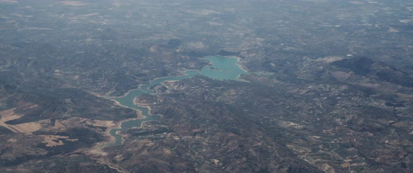 Airplane Window Flying Over Landscape