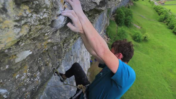 A man rock climbing up a mountain.