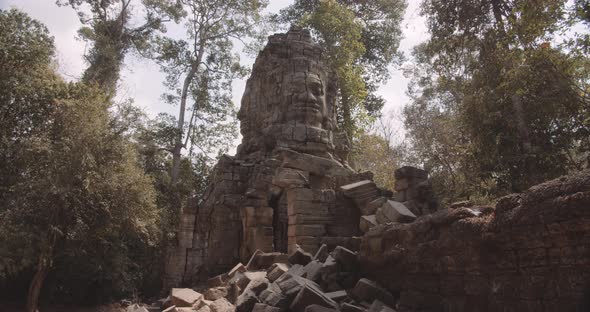 Steady View of Ancient Ruins Constructed of Buddha Face on Light Grey Granite