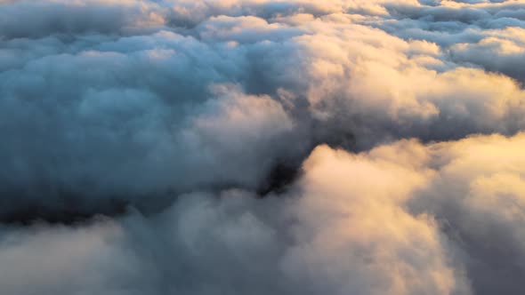 Reveal Footage of Aerial View From Above at High Altitude of Dense Puffy Cumulus Clouds Flying in