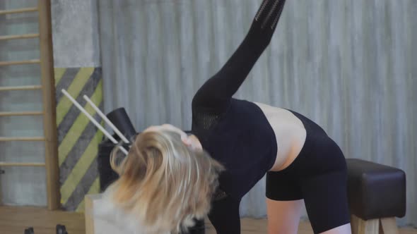 Young Athletic Blonde Woman Doing Body Stretching Exercises Warm-Up Before Training