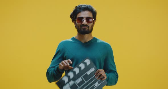 Cheerful Man Clapping Clapperboard