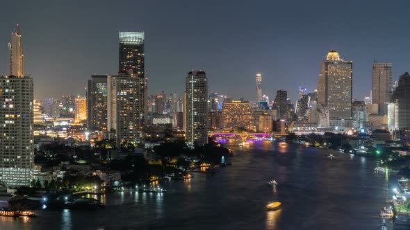 Time lapse of aerial view of boats and Taksin Bridge with Chao Phraya River in Bangkok, Thailand.