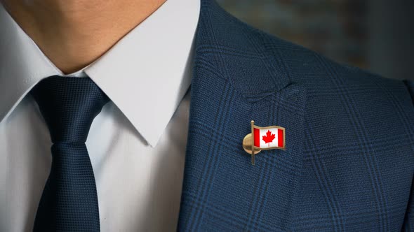 Businessman Walking Towards Camera With Country Flag Pin Canada