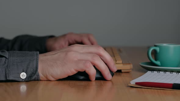 Man Hands Typing on a Keyboard on Workplace