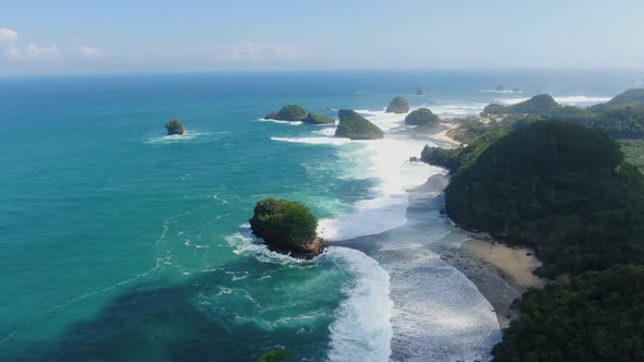 Tropical paradise Asmara beach washed by calm ocean waves Java Indonesia, aerial