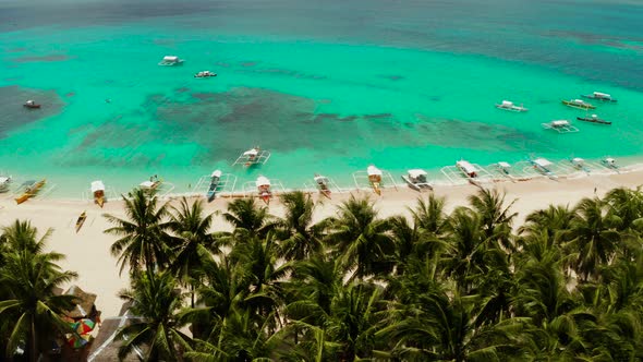 Tropical Daco Island with a Sandy Beach and Tourists