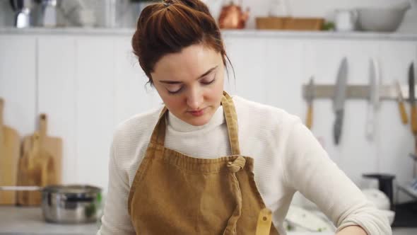 Female cooking stew at home