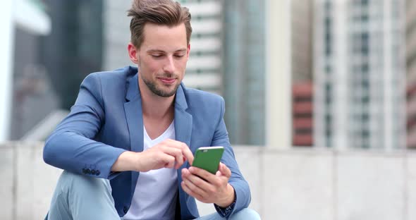 Caucasian Businessman Look at Mobile Phone in Hong Kong