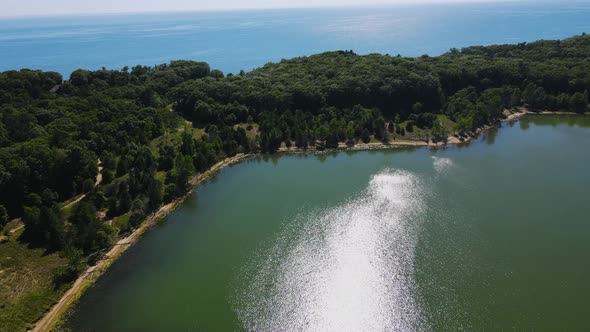 Rising and panning to show Lake Michigan over the lake at Dune Harbor.