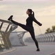 Sportswoman Warming Up Near Railing on Embankment - VideoHive Item for Sale