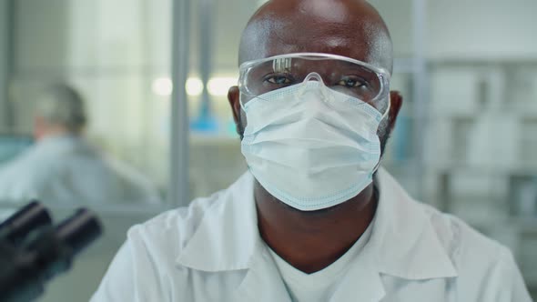 Portrait of African American Scientist in Mask and Glasses in Lab