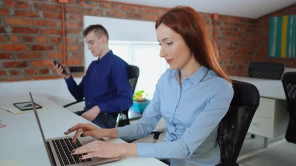 Two Young Employees in Office Loft