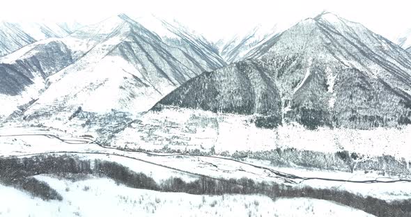 Aerial view of beautiful snowy mountains in Pasanauri, Georgia