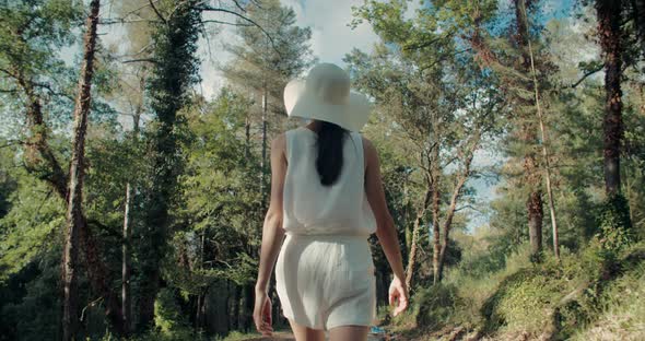 Inspired Young Adult Woman Walk Through Forrest on Country Road