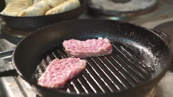 Chef prepares a delicious meat in the grill pan. Perfect steak.