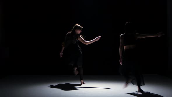 Sensual Contemporary Dance Performance of Two Dancers on Black, Shadow