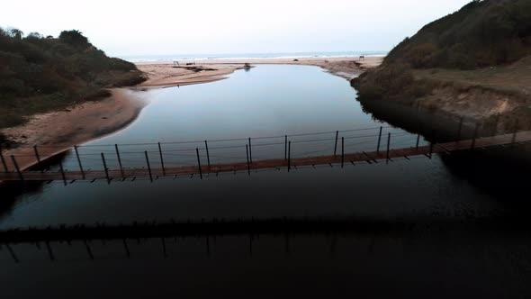 Aerial view of footbridge over coastal river