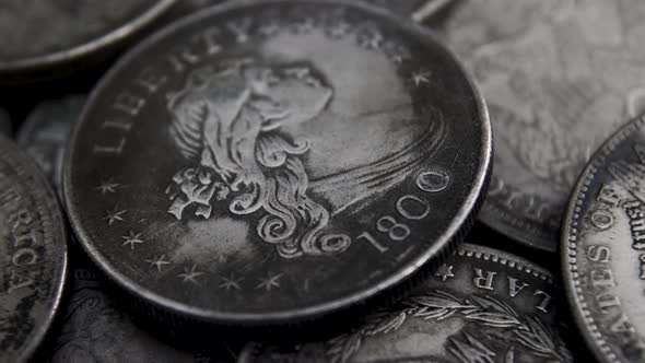 Close-up Silver Coin Rotating on a Wooden Table. Spinning American Dollars Coin 4K