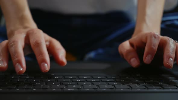 Caucasian female hands texting on laptop keyboard close up.