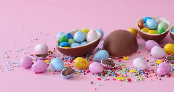 Happy Easter overhead with Easter eggs and decorations on a Pink Background. Dolly shot