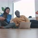 Young couple sitting on the floor shopping online for furniture - VideoHive Item for Sale