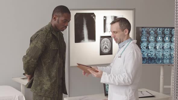 African American Soldier Talking to Radiologist Doctor
