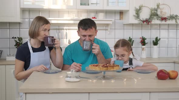 Cheerful Family Having Breakfast in Kitchen