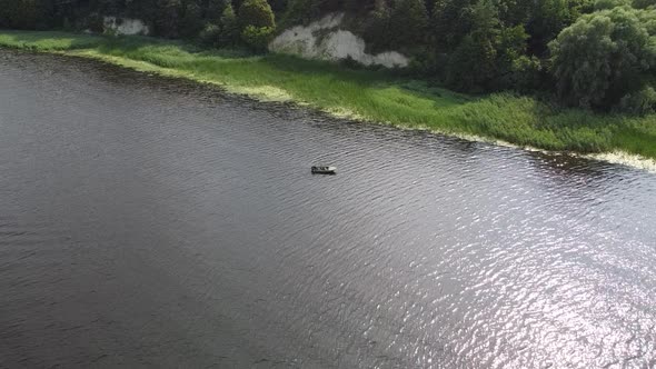 Drone Flying Above a River with a Fast Driving Speedboat While Sunset