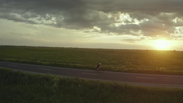 A Cyclist is Riding Slowly Along the Highway