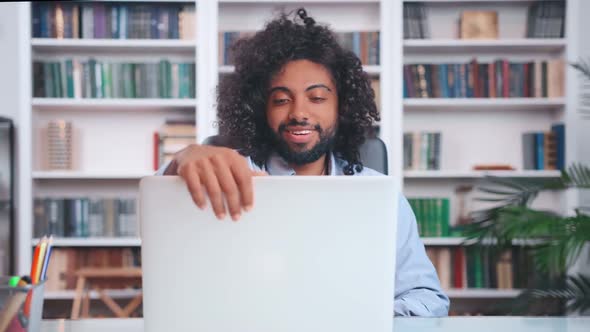 Young Inspired Indian Man Opens Laptop and Starts Actively Typing