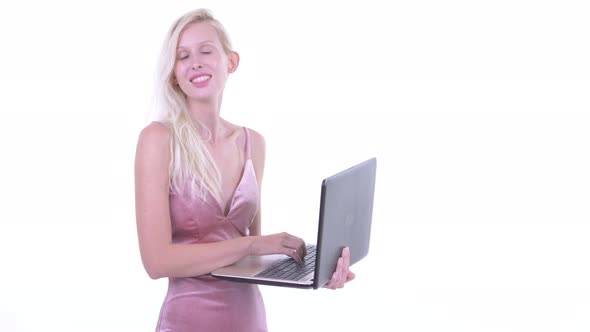 Happy Young Beautiful Blonde Woman Thinking While Using Laptop