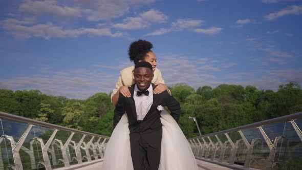 Front View of Cheerful African American Groom with Toothy Smile Walking to Camera in Slow Motion