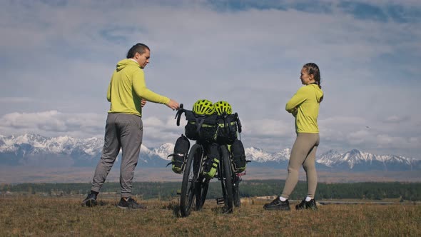 The Man and Woman Travel on Mixed Terrain Cycle Touring with Bikepacking. The Love Couple Journey