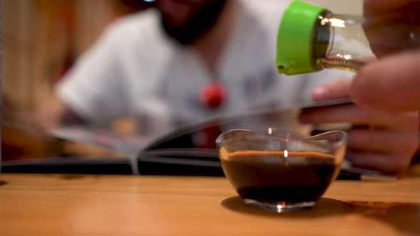 Putting soy sauce in a container in a restaurant. Oriental cuisine