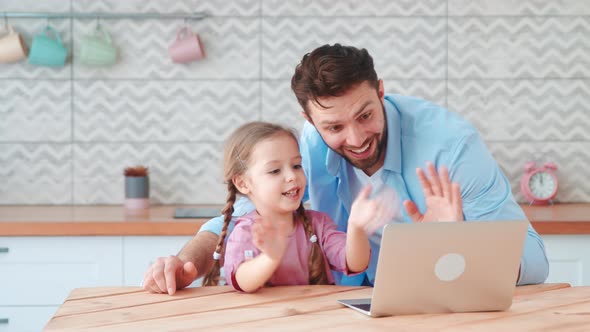 Young family with a child talking using a microphone and webcam