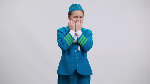 Nervous Shy Caucasian Girl in Stewardess Uniform Biting Nails Looking at Camera