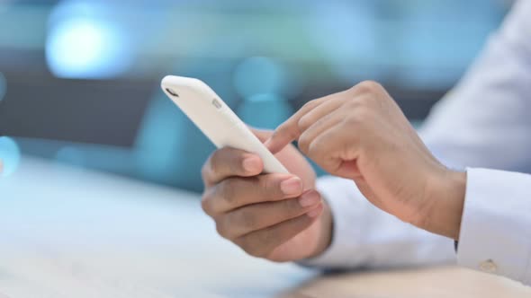 Close Up of African Businessman Using Smartphone