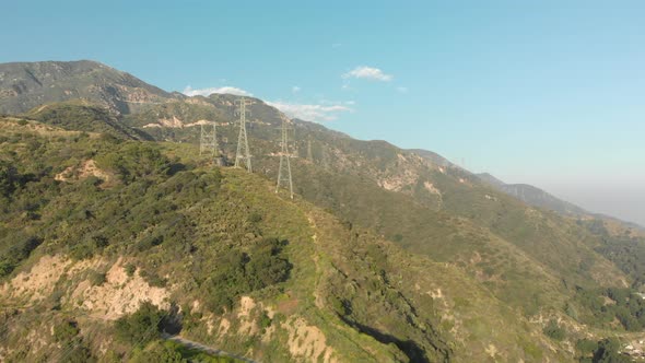 Aerial of Power Lines on a Verdant Mountain