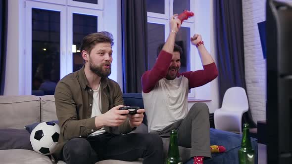 30s Men Enjoying Video Games and Celebrating Joint Victory Giving Each other High Five